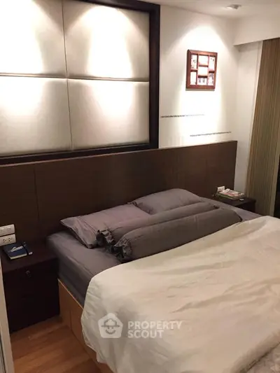 Cozy modern bedroom with stylish decor and wooden accents