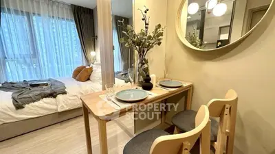 Modern studio apartment with cozy dining area and stylish bedroom