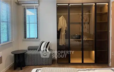 Modern bedroom with stylish wardrobe and cozy seating area