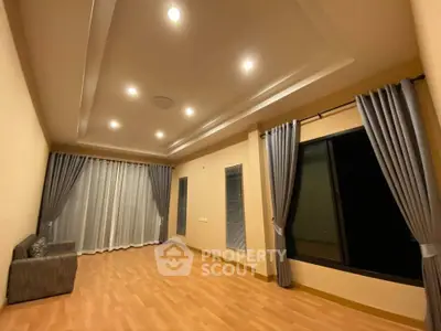 Spacious living room with elegant curtains and recessed lighting