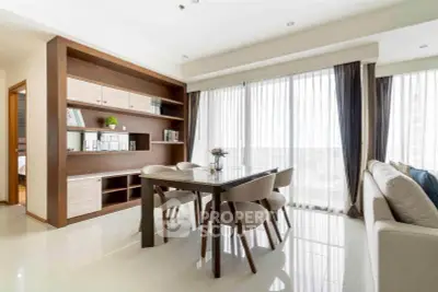 Elegant dining area with modern furniture and large windows offering a stunning city view.