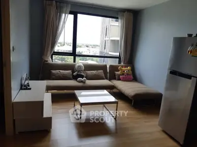 Cozy living room with plush sofa, modern decor, and large window view.