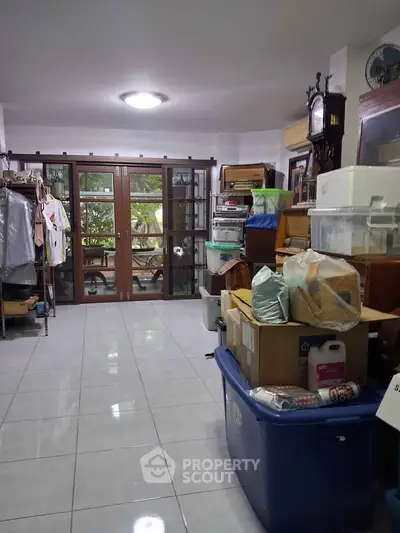 Spacious storage room with large windows and ample natural light, ideal for organizing and decluttering.