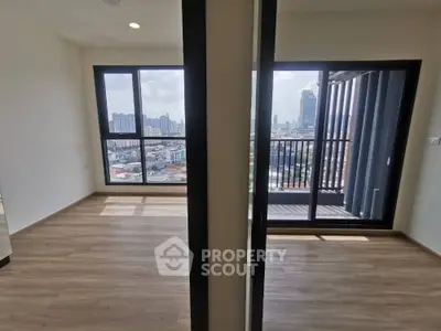 Spacious high-rise corner unit with expansive city views, featuring large windows and a private balcony for an urban oasis feel.