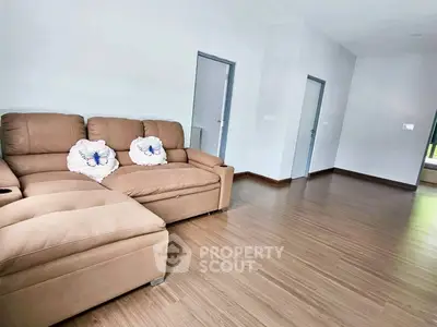Spacious living room with modern sofa and wooden flooring