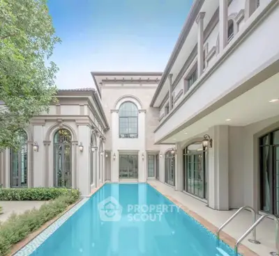 Luxurious mansion with elegant architecture and a stunning private pool.