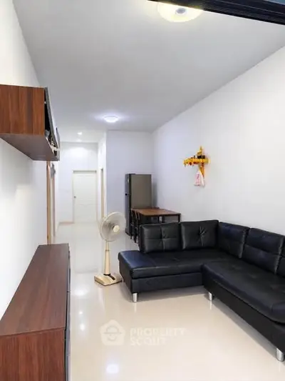 Modern living room with sleek black sofa and minimalist decor