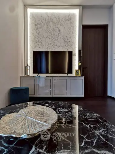 Luxurious living room with marble accents and modern TV setup