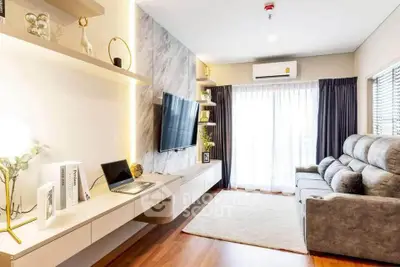 Modern living room with sleek design, featuring a wall-mounted TV, plush sofa, and elegant decor.