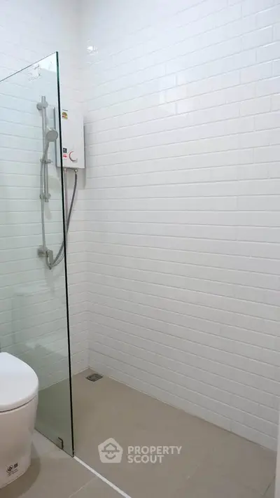 Modern bathroom with glass shower and white subway tiles