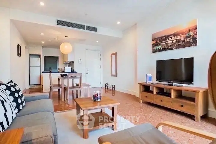 Spacious living room with modern decor and open layout, featuring a cozy seating area and dining space.