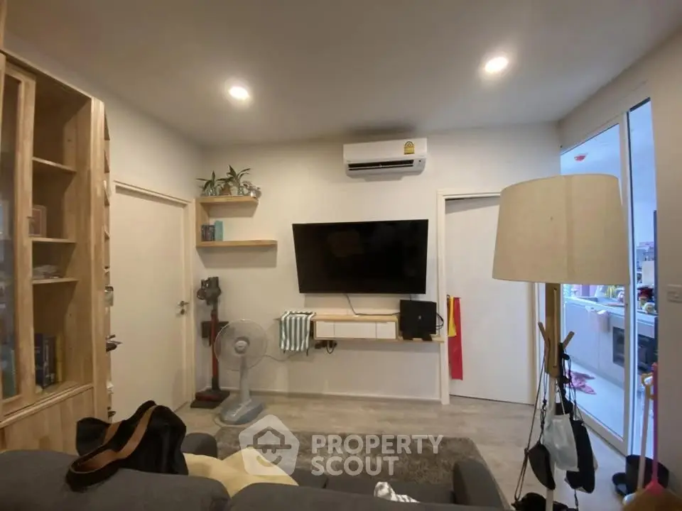 Cozy living room with modern decor and wall-mounted TV, perfect for relaxation and entertainment.