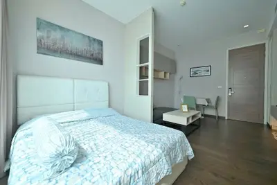 Modern bedroom with stylish decor and cozy ambiance in a contemporary apartment.