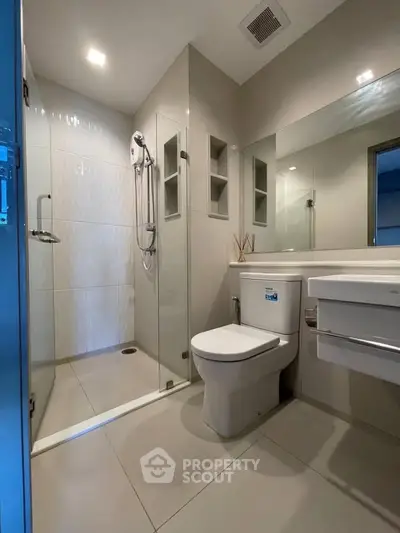 Modern bathroom with sleek shower and elegant fixtures in a contemporary apartment.