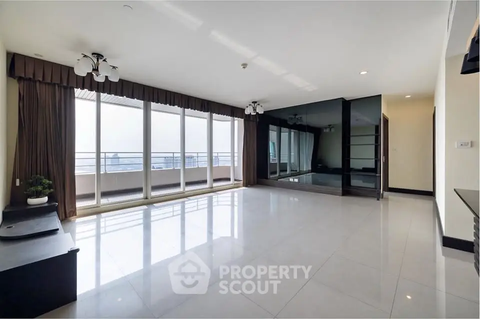 Spacious modern living room with large windows and balcony access