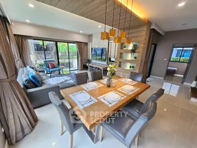 Luxurious open-plan living and dining area with modern decor and natural light.