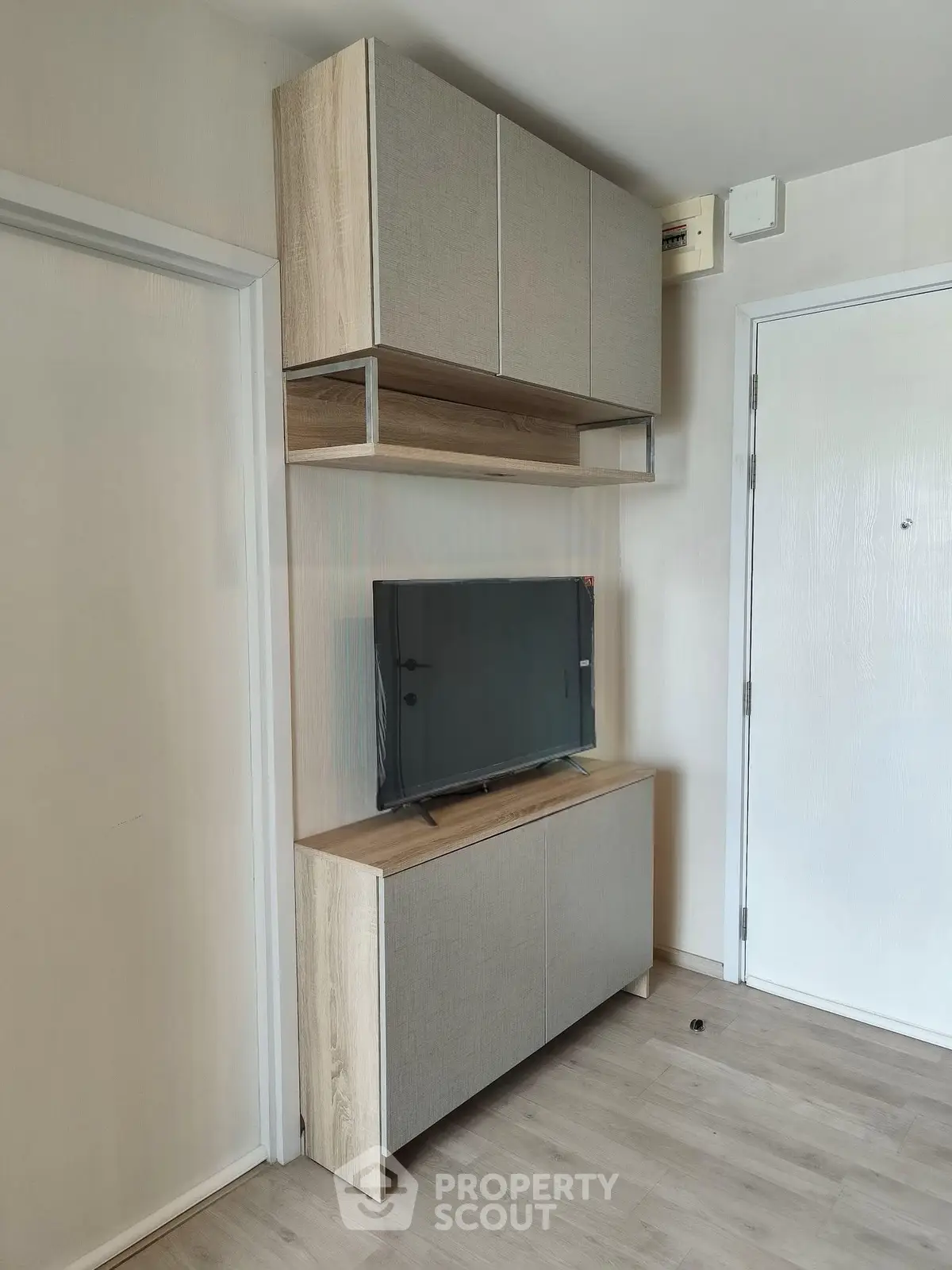 Modern living room with sleek TV cabinet and wall-mounted storage