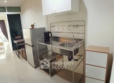 Modern kitchen with stainless steel sink and appliances in sleek apartment