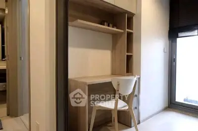 Modern study area with wooden desk and chair in a bright apartment