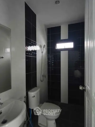 Modern bathroom with sleek black tiles and contemporary fixtures
