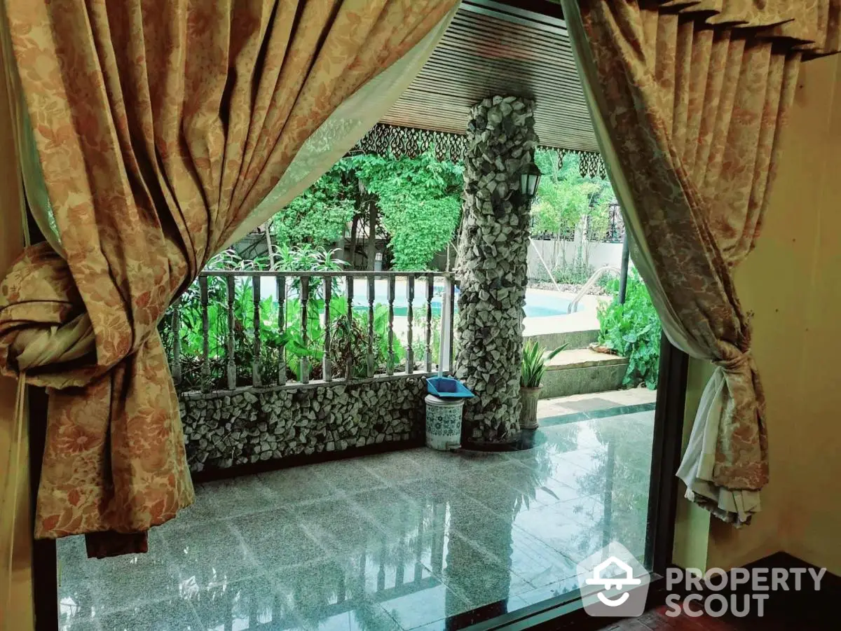 Luxurious home with elegant curtains and poolside view, perfect for relaxation and entertainment.