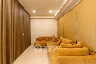 Spacious living room with modern design and cozy seating in a luxurious apartment.