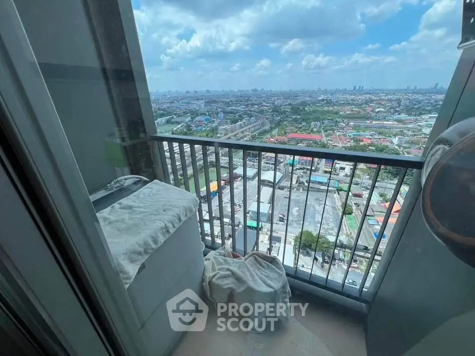 Stunning high-rise balcony with panoramic city views, perfect for relaxation and enjoying the skyline.