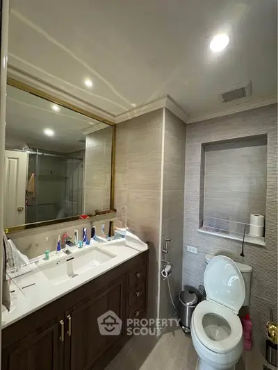 Modern bathroom with dual sinks and elegant wood cabinetry