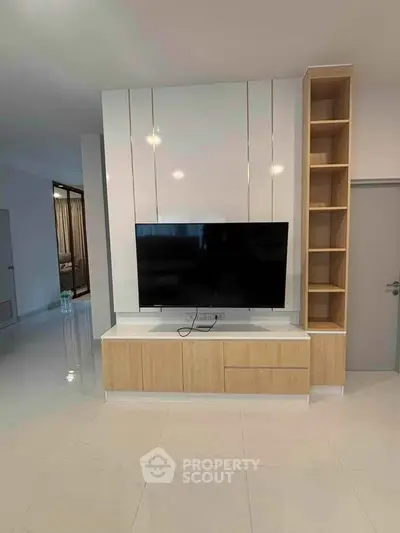 Modern living room with sleek TV unit and open shelving