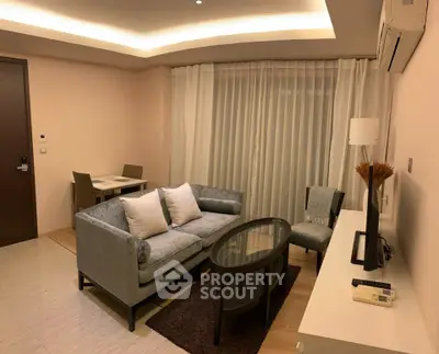 Modern living room with elegant furniture and ambient lighting, perfect for cozy evenings.