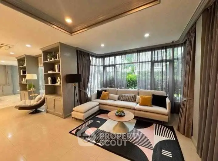 Spacious modern living room with large windows and stylish decor