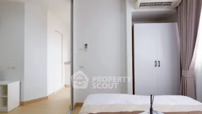 Modern bedroom with white wardrobe and air conditioning in bright apartment