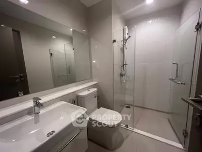 Modern bathroom with sleek fixtures and glass shower enclosure