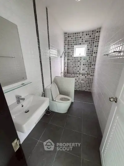 Modern bathroom with sleek tiles and compact design