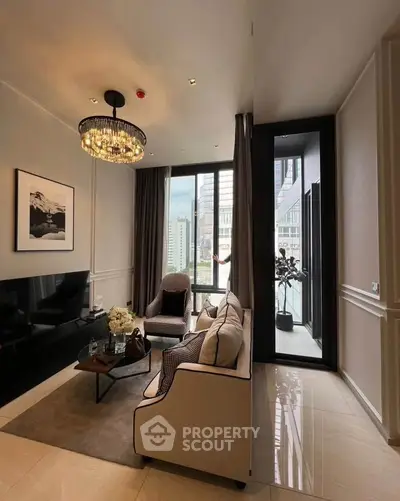 Luxurious living room with elegant chandelier and city view from large windows.