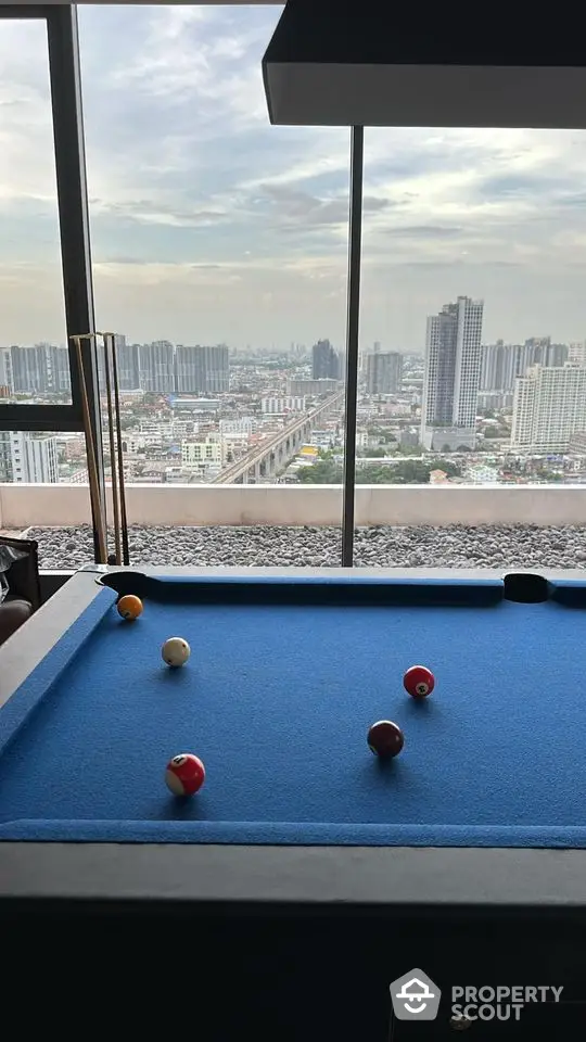 Luxurious rooftop with pool table offering stunning city skyline views