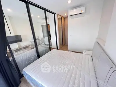 Modern bedroom with glass partition and air conditioning in a stylish apartment