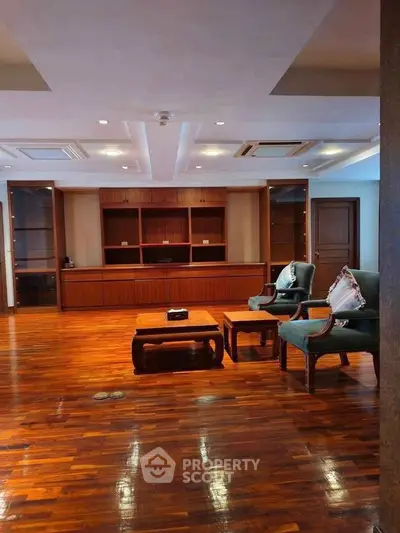 Spacious living room with elegant wooden flooring and stylish furniture