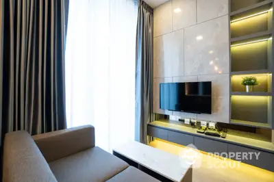 Modern living room with sleek design, featuring a wall-mounted TV and elegant lighting.