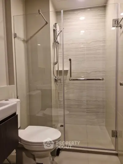 Modern bathroom with glass shower enclosure and sleek fixtures