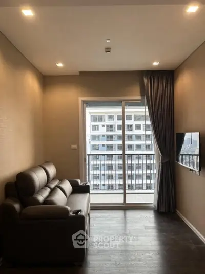 Modern living room with leather sofa and city view through large window.