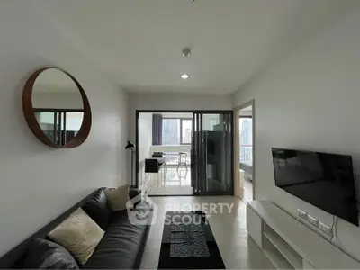 Modern living room with sleek furniture and city view balcony, perfect for urban living.