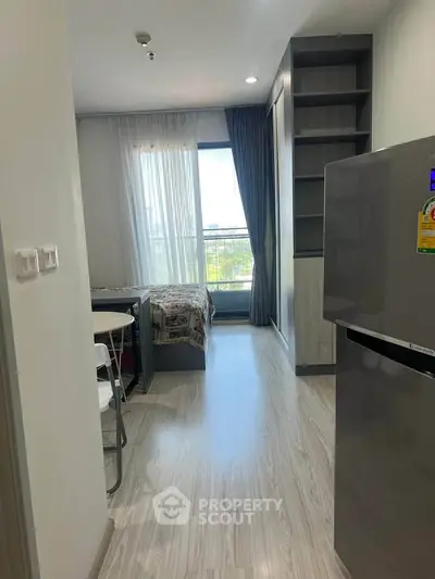 Modern studio apartment with sleek flooring and natural light