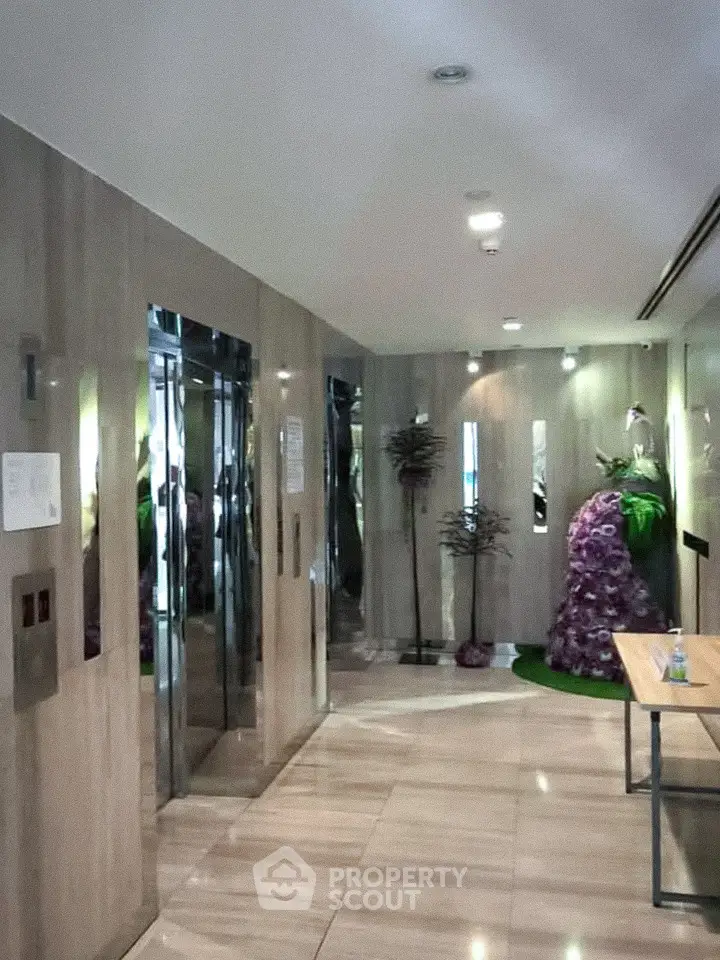 Elegant building lobby with modern elevators and stylish decor