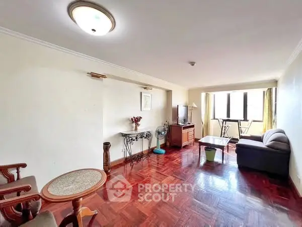 Spacious living room with hardwood floors and natural light