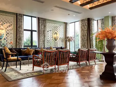 Luxurious living room with elegant decor and large windows offering natural light.