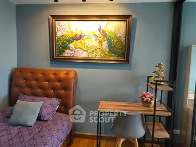 Charming bedroom with elegant decor and cozy workspace, featuring a vibrant peacock painting.