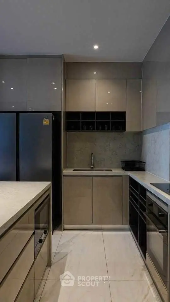 Modern kitchen with sleek cabinetry and built-in appliances, featuring a minimalist design.