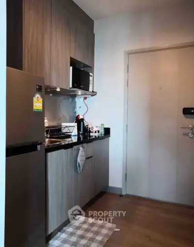 Modern compact kitchen with sleek cabinetry and stainless steel appliances