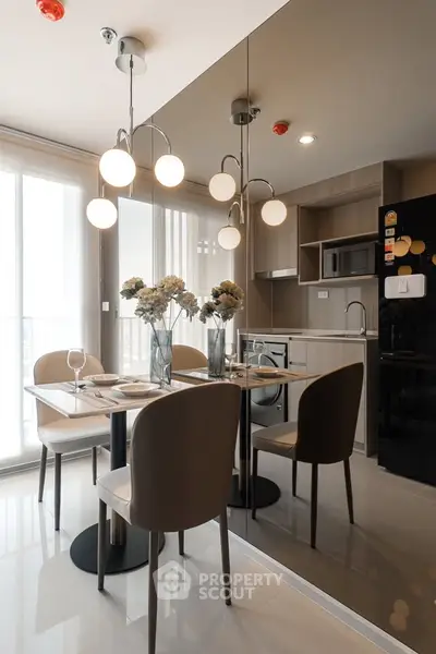 Modern kitchen with dining area, sleek cabinetry, and elegant lighting in a stylish apartment.